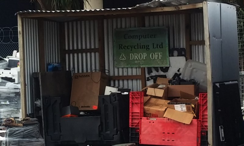 Antec Lanboy computer case atop a tower of e-waste