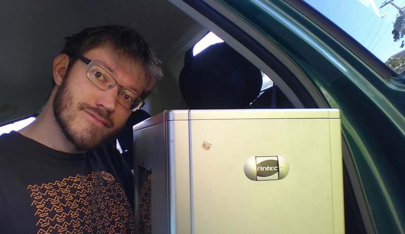 Photo of an Antec Lanboy computer case and Matthew sitting in the back seat of a car